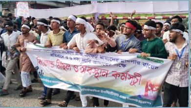 Students marched with white shrouds on their heads